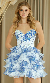 Woman wearing a strapless blue and white floral short dress against a neutral background