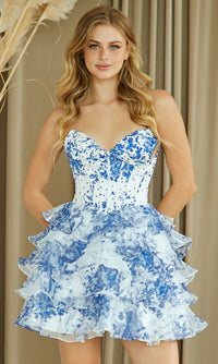 Woman wearing a strapless blue and white floral short dress against a neutral background