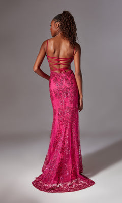 A woman stands facing away, wearing the Aerie Couture 206 Strappy-Back Long Prom Dress in bright pink with thin crisscross straps and an open back against a plain gray background.