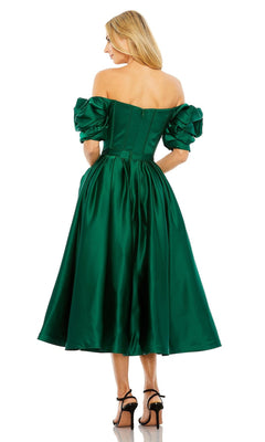 A woman seen from the back wears the Off-Shoulder Wedding Guest Dress: Mac Duggal 20706—an emerald green satin midi with puffed sleeves, paired with black heels—an elegant choice for a semi-formal wedding guest.