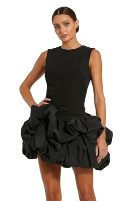 Woman in the Mac Duggal 20709 Short Black Bubble Party Dress, featuring a fitted bodice and voluminous mini bubble skirt, stands against a plain white background.