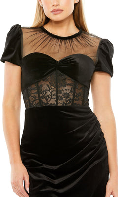 Woman wearing the Short Wedding Guest Dress 20742 by Mac Duggal, a black fitted dress with a sweetheart neckline, sheer mesh and lace bustier bodice, short puff sleeves, and gathered hip detail.