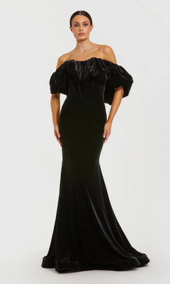 A woman models the Mac Duggal 20766 long formal dress in black, featuring off-the-shoulder styling and floor-length puffed sleeves, posed elegantly against a white background.