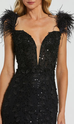 A woman in the Long Formal Dress 20889 by Mac Duggal: black fitted gown with a v-neckline, sequin embellishments, and striking feather shoulder straps.