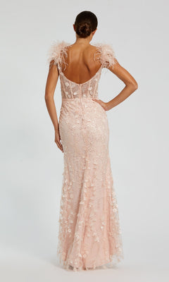 A woman stands with her back to the camera, wearing the Mac Duggal Long Formal Dress 20889—an elegant pale pink, floor-length gown with a sweetheart neckline, feathered shoulders, and delicate floral embellishments.