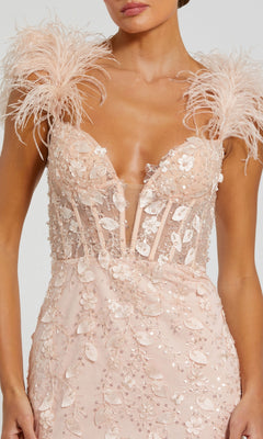 A woman wearing the Long Formal Dress 20889 by Mac Duggal—a light pink gown featuring floral appliqués, beadwork, a deep v-neckline, and dramatic feather straps.
