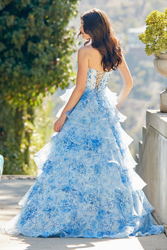 The Amelia Couture 2092 long prom dress features a strapless floral corset bodice with a floor-length, tiered ruffled skirt and a lace-up back.