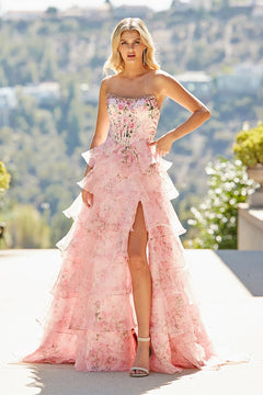 The Amelia Couture 2092 long prom dress is a strapless, floor-length floral gown with a corset bodice, tiered skirt, and a high thigh slit.