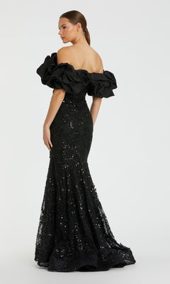 A woman wearing the Mac Duggal 21033—a long rose pink beaded prom gown—stands against a plain white background.