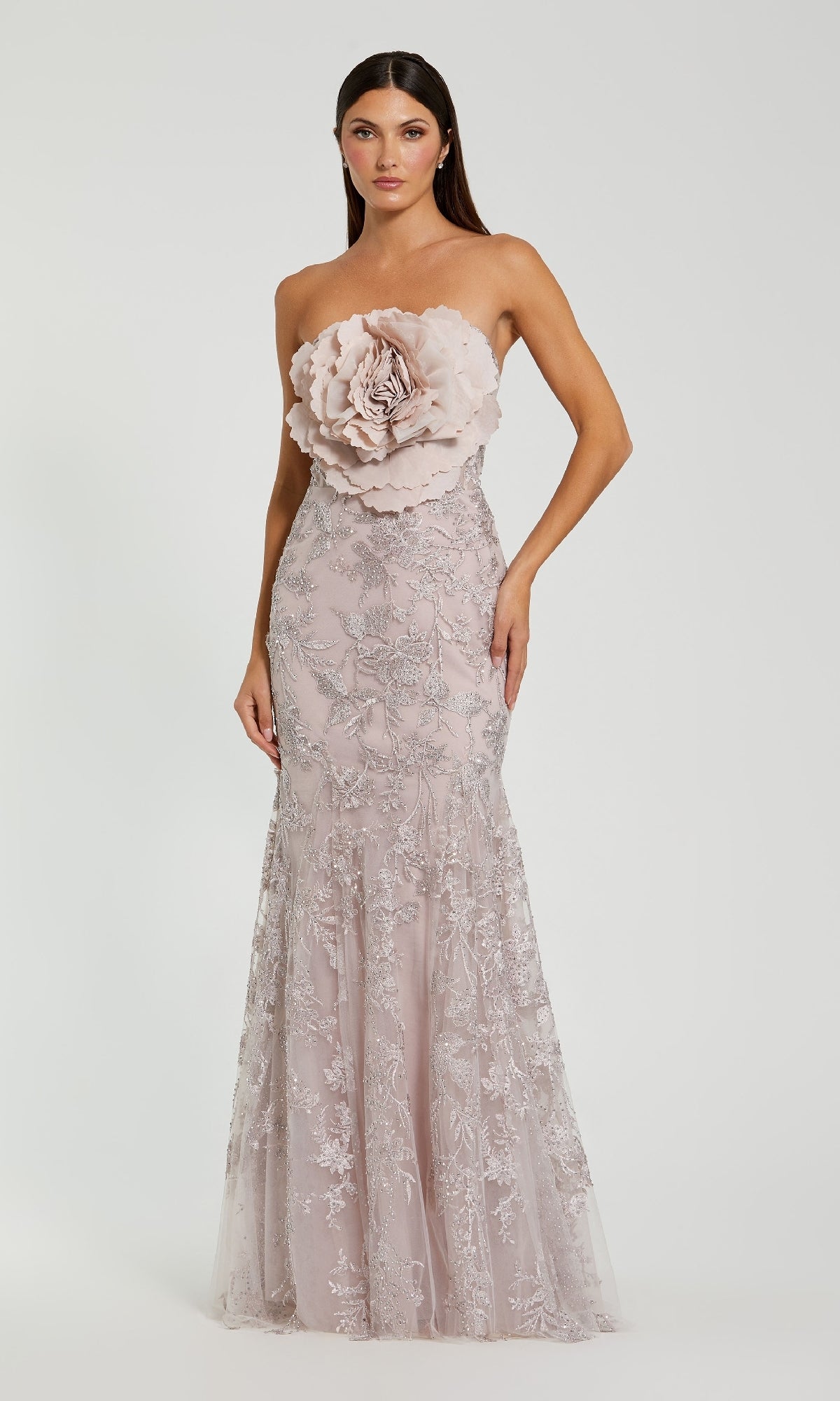A woman in the Mac Duggal 21036 Strapless Long Floral Prom Dress, light pink with a floral applique bodice and lace details, exudes timeless elegance in this vintage-inspired formal gown.