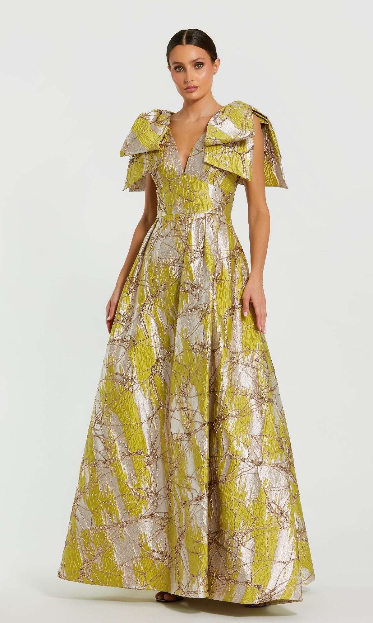 Woman wearing a yellow and white patterned evening gown on a white background