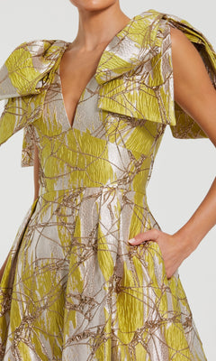 Close-up of a person wearing a patterned evening gown with a neutral background