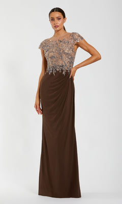 A woman poses against a white background in the Mac Duggal 21100 Beaded-Bodice Long Formal Dress, featuring a chocolate brown floor-length skirt and sheer embellished cap-sleeve bodice.