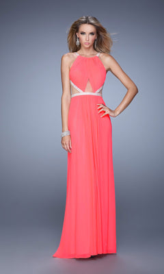 A woman poses against a plain gray background wearing the Long A-Line Prom Dress: La Femme 21145, a sleeveless coral gown with a halter neckline, cutouts at the waist and chest, and silver beaded accents.