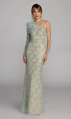 A woman wears the Mac Duggal 21203 long formal dress, featuring a floor-length, one-shoulder design with shimmering geometric beadwork and a ruffled shoulder detail, standing against a plain background.