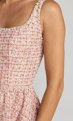 Close-up of the Midi Party Dress: Mac Duggal 21207, featuring pink tweed fabric with a scoop neckline and pearl embellishments along the edge, worn by a model against a plain gray background—offering a refined and elegant look.