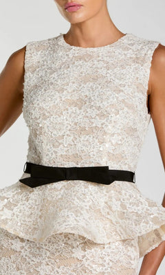 A person wearing the Mac Duggal 21228 long formal dress, featuring elegant ivory lace in a sleeveless peplum style, accented with a black belt and bow detail at the waist—perfect for formal occasions.