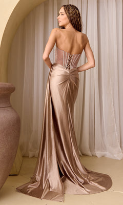 Woman showing the back of a taupe evening gown she's wearing, standing against a neutral background.