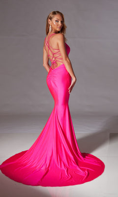Woman in the Strappy Long Mermaid Prom Dress: Aerie Couture 212—bright pink, fitted with a long train and crisscross back—posing against a plain backdrop.