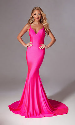A woman stands confidently with hands on hips, wearing the Aerie Couture 212 Strappy Long Mermaid Prom Dress in hot pink against a plain backdrop.