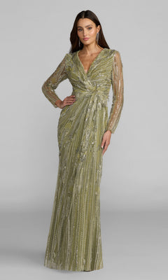 A woman stands wearing the Mac Duggal 21306 long formal dress in pistachio, featuring hand-embellished details, long sheer sleeves, and a wrap-style waist, posing against a plain gray background.