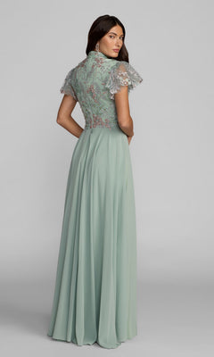 A woman stands looking over her shoulder in the Mac Duggal 21314 long formal dress—featuring a sage green hue, floral embroidery on the bodice, and short sheer sleeves.