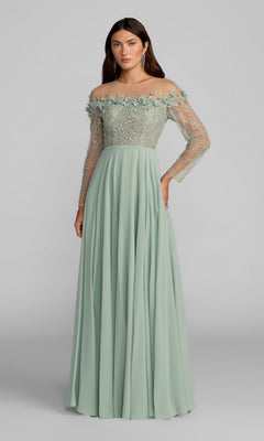 A woman wears the Mac Duggal 21315 long formal dress in sage, featuring off-the-shoulder styling, sheer sleeves, and floral embellishments on the bodice, as she stands against a plain gray background.