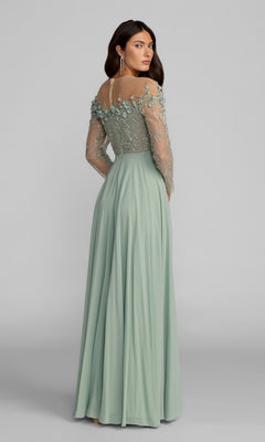 A woman wearing the Mac Duggal 21315 long formal dress in sage green, featuring sheer embroidered long sleeves and floral details on the bodice, stands against a plain gray background.