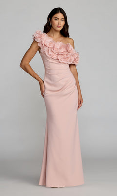 A woman wearing the Mac Duggal 21383 long formal dress in blush, featuring a floor-length one-shoulder design with dramatic 3D floral appliques cascading across the bodice, stands against a plain background.