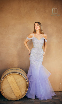 A woman in the Open-Back Beaded Mermaid Prom Dress: Lucci Lu 2147 poses beside a large wooden barrel against a plain tan wall.