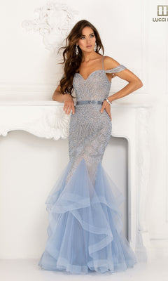 A woman poses in the Lucci Lu 2147 Open-Back Beaded Mermaid Prom Dress, featuring a fitted light blue silhouette with off-the-shoulder beaded lace details and a layered tulle skirt, against a white ornate backdrop.