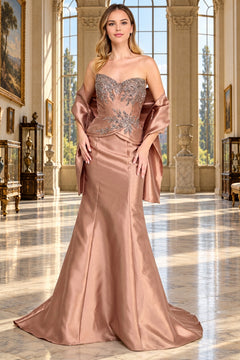 Amelia Couture 2162 is a strapless, floor-length rose gold beaded evening gown with a matching shawl draped over the arms.