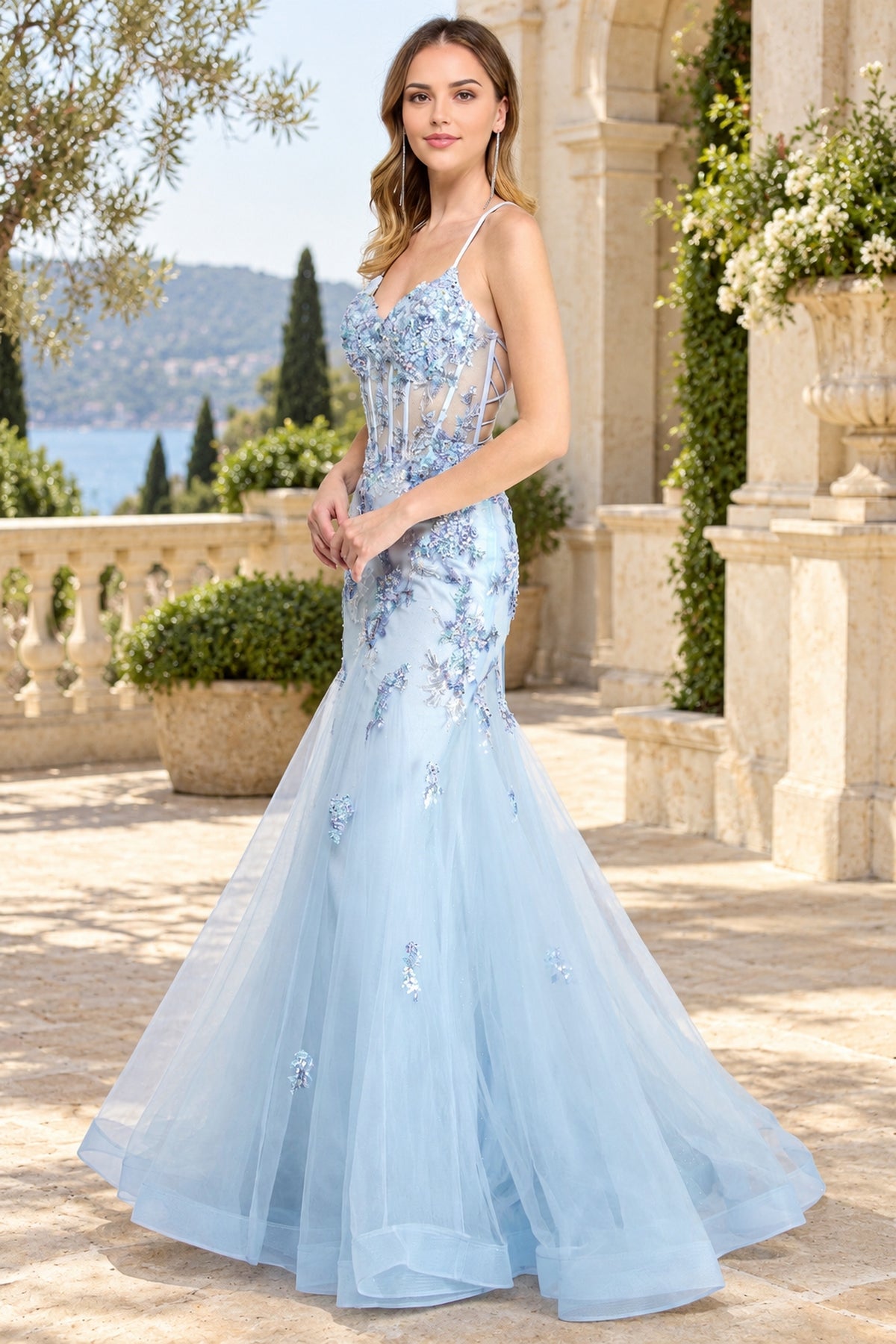Amelia Couture 2164 floor-length, light blue mermaid prom dress featuring a corset-style bodice, thin straps, and delicate floral lace appliqués.