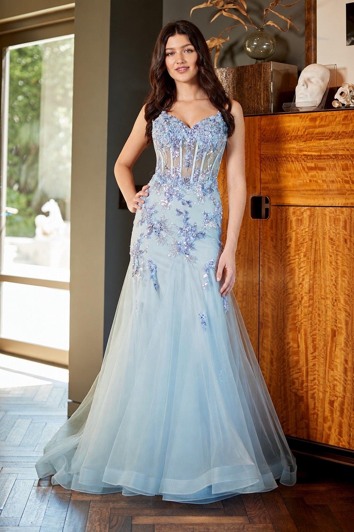 Amelia Couture 2164 light blue, floor-length floral prom dress with a corset-style bodice featuring sequin flower appliqués and a tulle skirt.