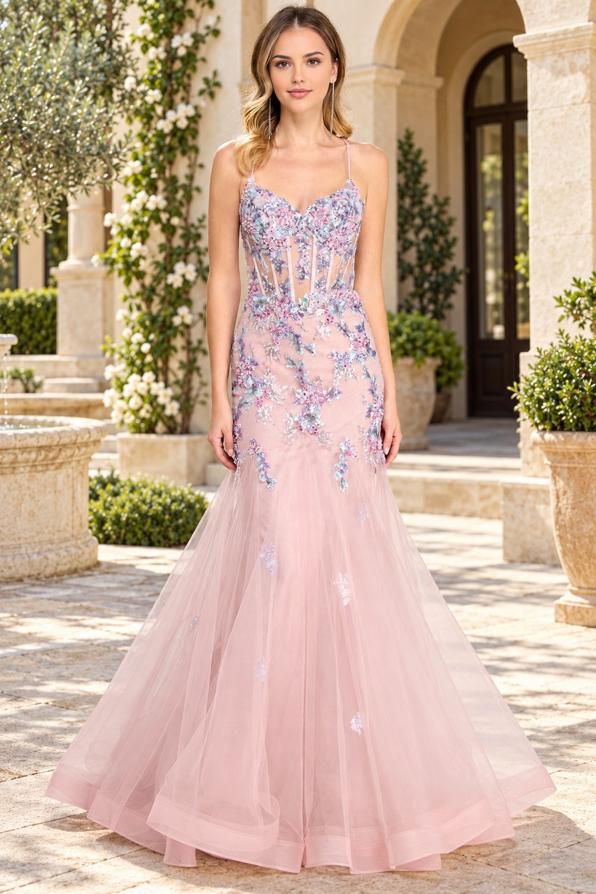Amelia Couture 2164 floor-length, light pink mermaid prom dress with a corset-style bodice decorated with sequin flower appliques.