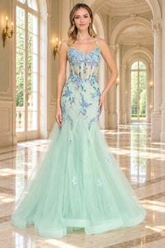 Amelia Couture 2164 mint green, floor-length mermaid prom dress with a sheer corset bodice featuring blue floral embroidery, beading, and sequin flower appliques.
