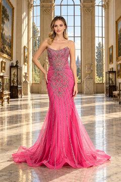 Amelia Couture 2165 is a strapless, floor-length fuchsia beaded prom dress with intricate silver beadwork and a flared tulle mermaid skirt.