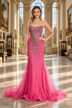 Amelia Couture 2165 is a strapless, fuchsia mermaid prom dress featuring intricate silver beaded embroidery across the bodice that cascades down the skirt.