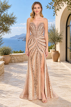 Amelia Couture 2167 is a champagne-colored, strapless floor-length prom dress featuring a deep V-neckline, vertical sequin stripes, and a high side slit for a retro glam look.