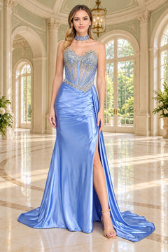 A woman wearing a blue Amelia Couture 2169 floor-length gown with a beaded corset-style bodice, a high slit, and a choker neckline.
