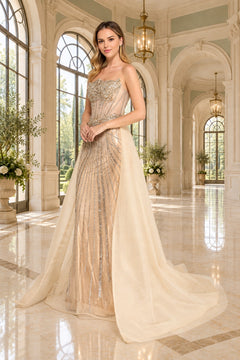 Amelia Couture 2172 long prom dress in champagne, featuring a strapless sweetheart neckline, gold beading, and a sheer detachable overskirt.