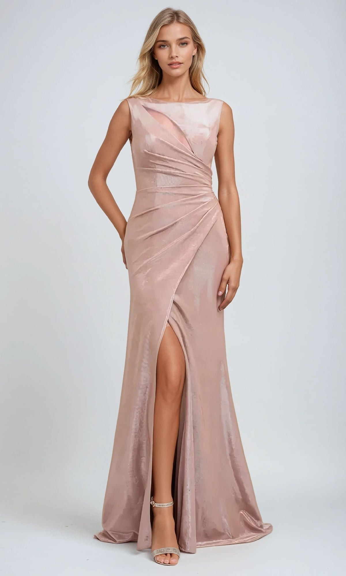 A woman wearing the Juliet 218 Long Prom Dress— a sleeveless, blush pink satin gown with a ruched waist, faux-wrap bodice, and high leg slit—stands against a plain light background.