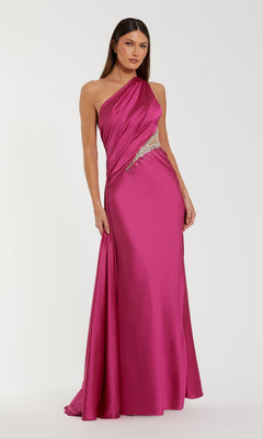 A woman models the Mac Duggal 2210 Cut-Out One-Shoulder Formal Dress in bright pink, featuring a beaded waist cutout, standing against a plain white background.