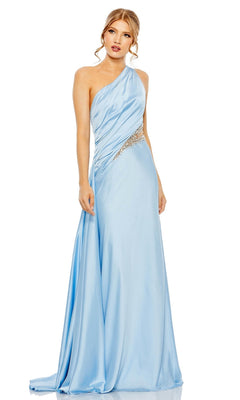 A woman wears the Mac Duggal 2210 Cut-Out One-Shoulder Formal Dress in light blue, featuring a jeweled waistband, standing against a plain white background.