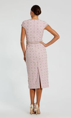 Woman standing with back to camera, wearing the Mauve Pink Wedding Guest Dress: Mac Duggal 2234—an embellished, beaded midi dress paired with gold heels, perfect for wedding guests.