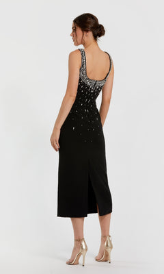 Black dress with beaded details on a white background