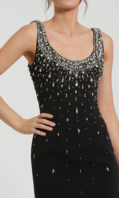 Black dress with silver embellishments on a white background