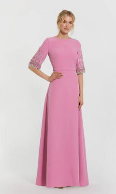 A woman poses against a plain white background in the Mac Duggal 2270 Short Sleeve Sleek Formal Dress—a floor-length pink gown featuring embellished short sleeves and a fitted waist.