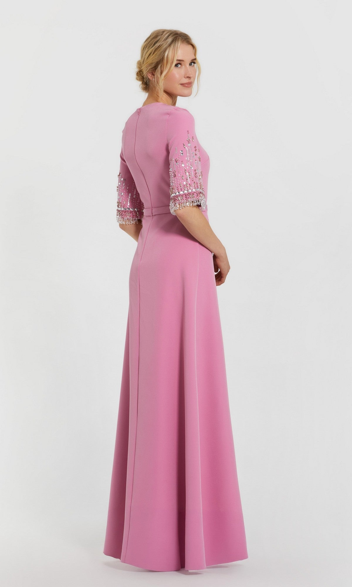 Woman in a Mac Duggal 2270 Short Sleeve Sleek Formal Dress stands turned slightly away against a plain white background.
