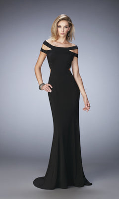 A woman models the La Femme Dress 22728, showcasing its strappy off-the-shoulder neckline and cutout straps, set against a plain gradient background.